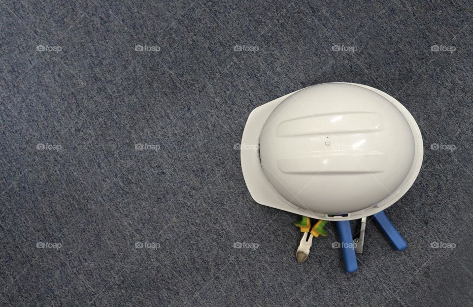 Photo of a white helmet with handyman equipment or tools