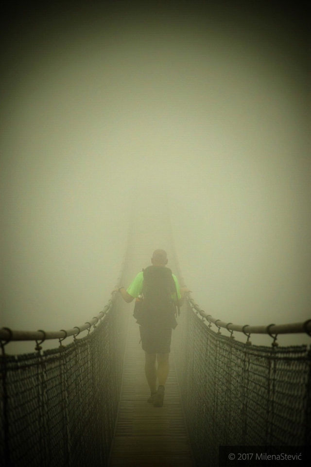 misty bridge with hiker - leap of faith. 