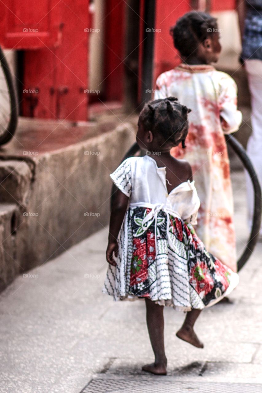 Cute Girl. Cute girl jumping around with barefoot in Stone Town, Zanzibar