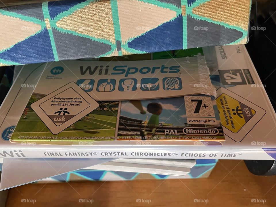 The video games Final Fantasy and WiiSports in a colorful box 