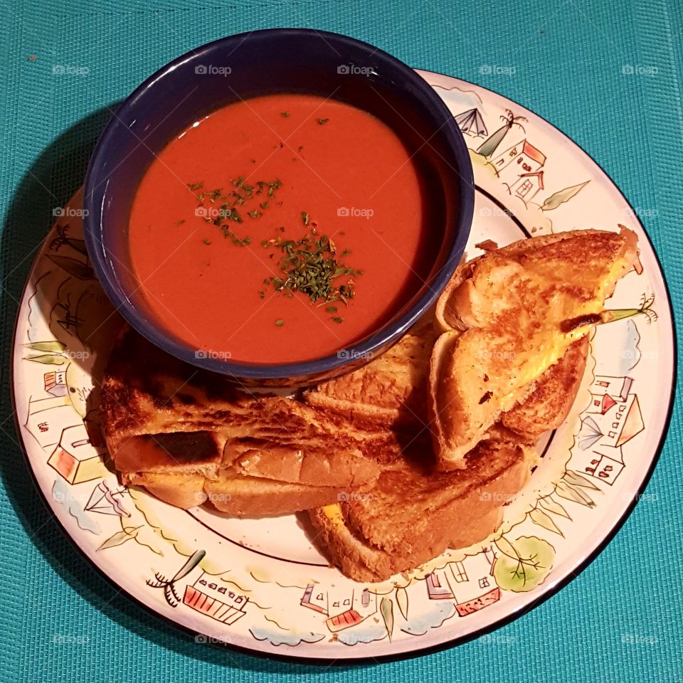 Tomato soup with hot ham, cheese, and eggs sandwich, made by my son, double good!