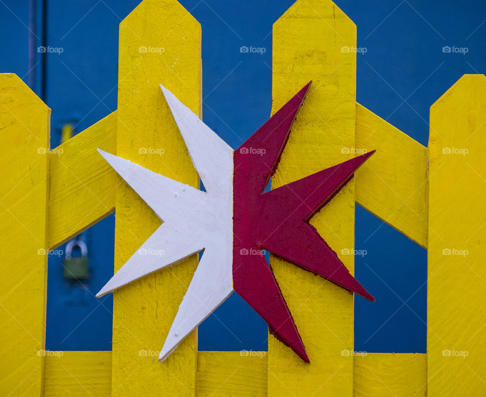 colourful gate featuring Maltese cross