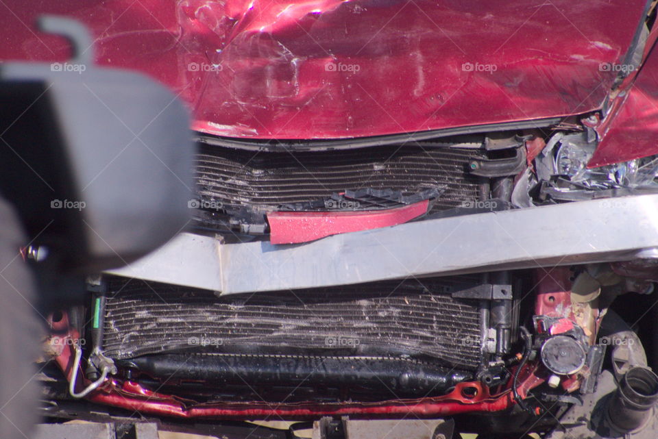 car crash fromt end damaged red automobile