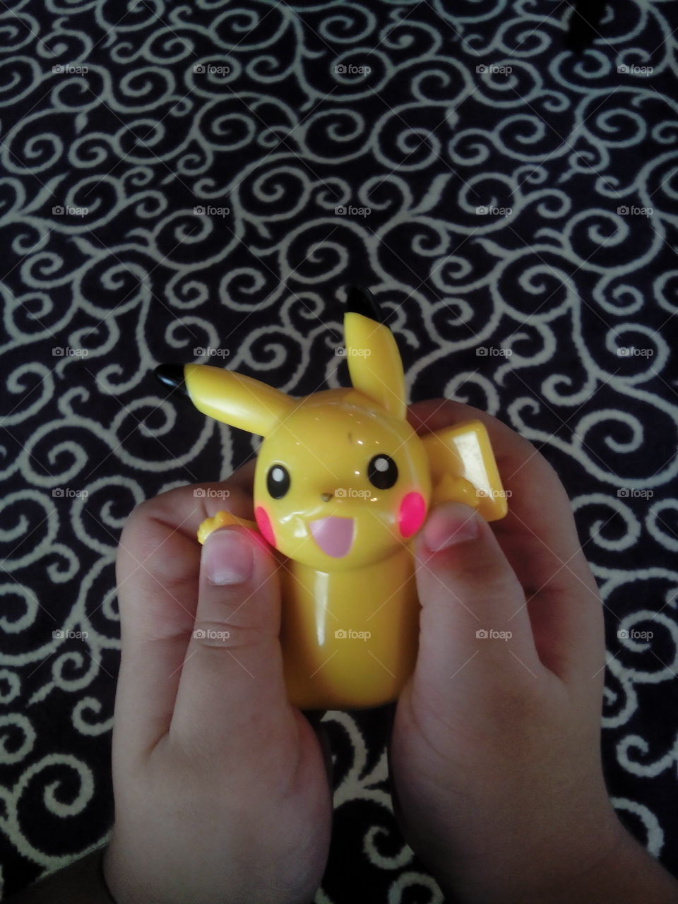 Pikachu on hand of a kid
