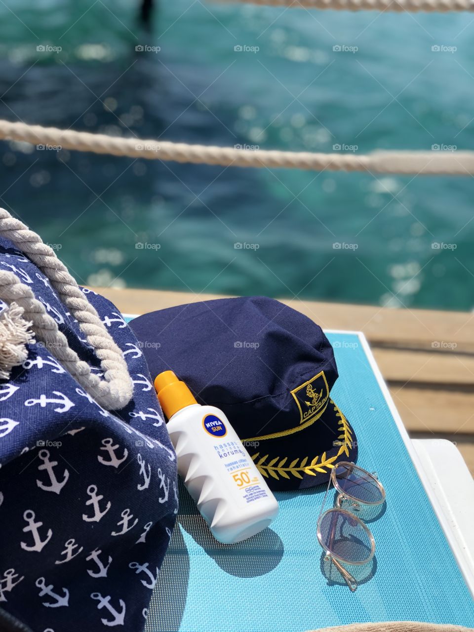 nivea cream on sea beach with bag