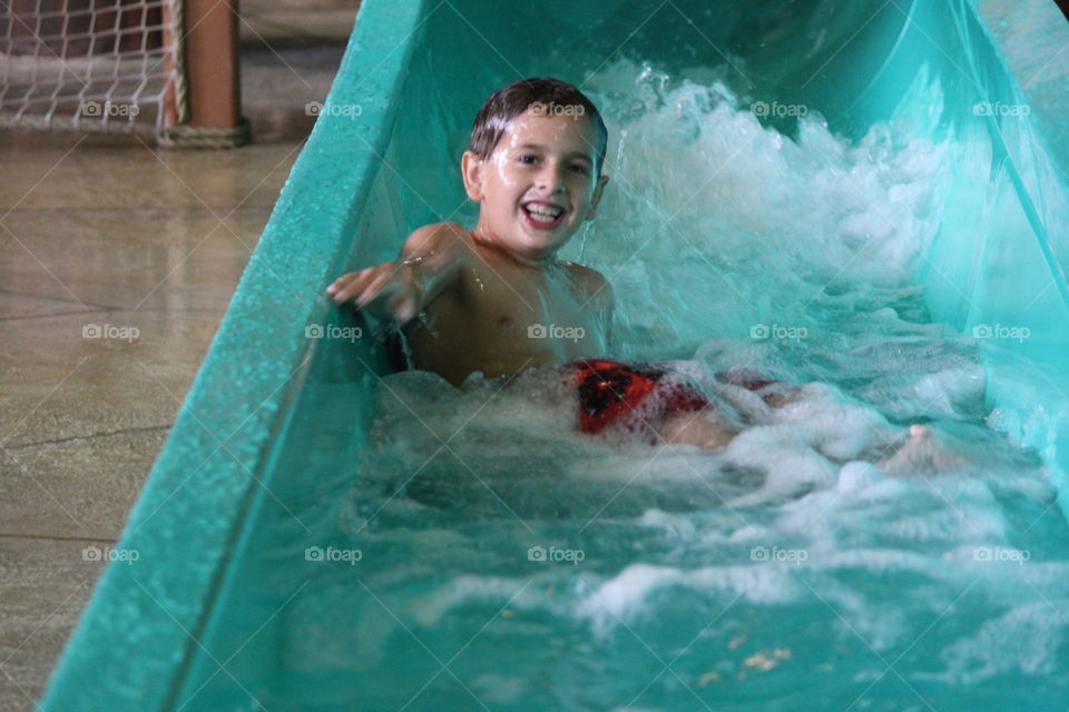 Down the chute . Boy going down water slide at great wolf lodge