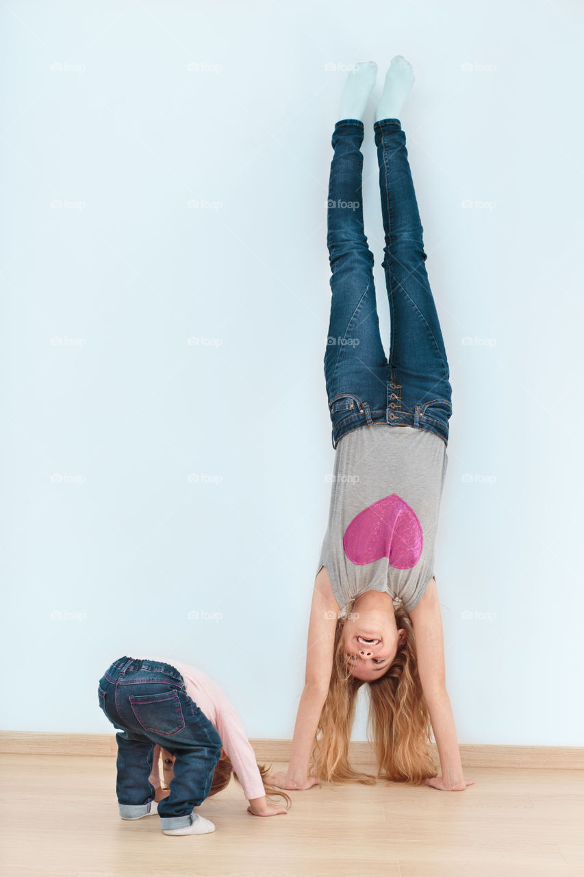 Mother and daughter upside down on wall