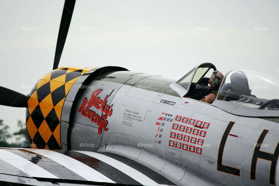 WWII war plane on taxiway with pilot