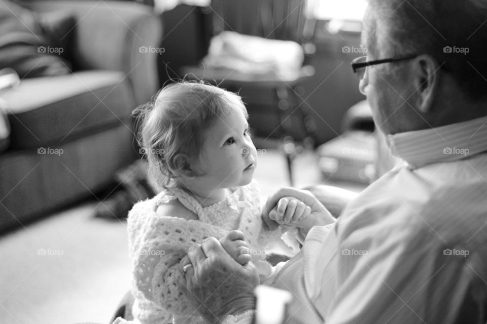 Tell me Grandpa. A grandfather talks to his granddaughter who is attentively listening 