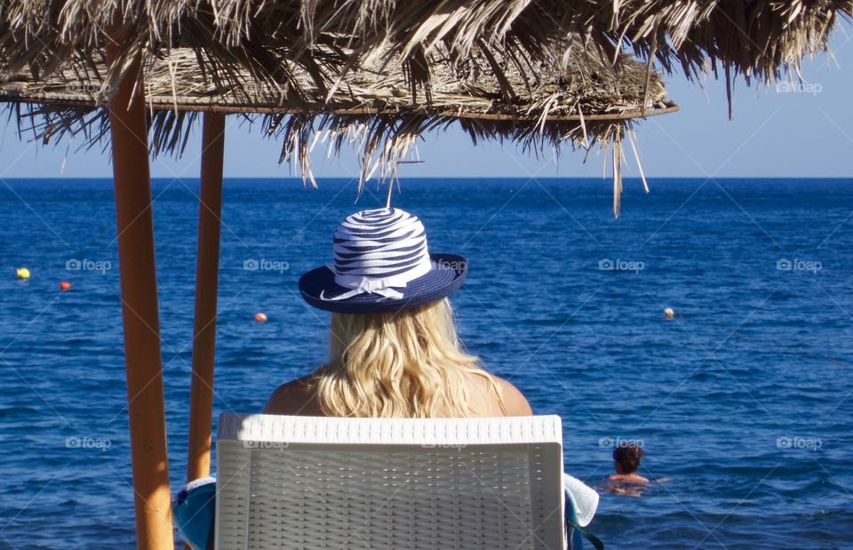 Woman relaxing on the beach. Woman enjoying the beach. 