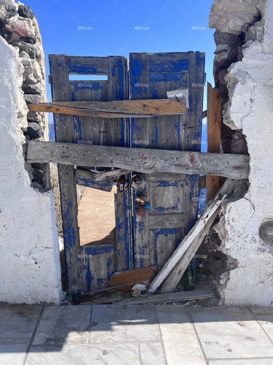 Door to the sea in Santorini. Weathered and warn by the salty air. 