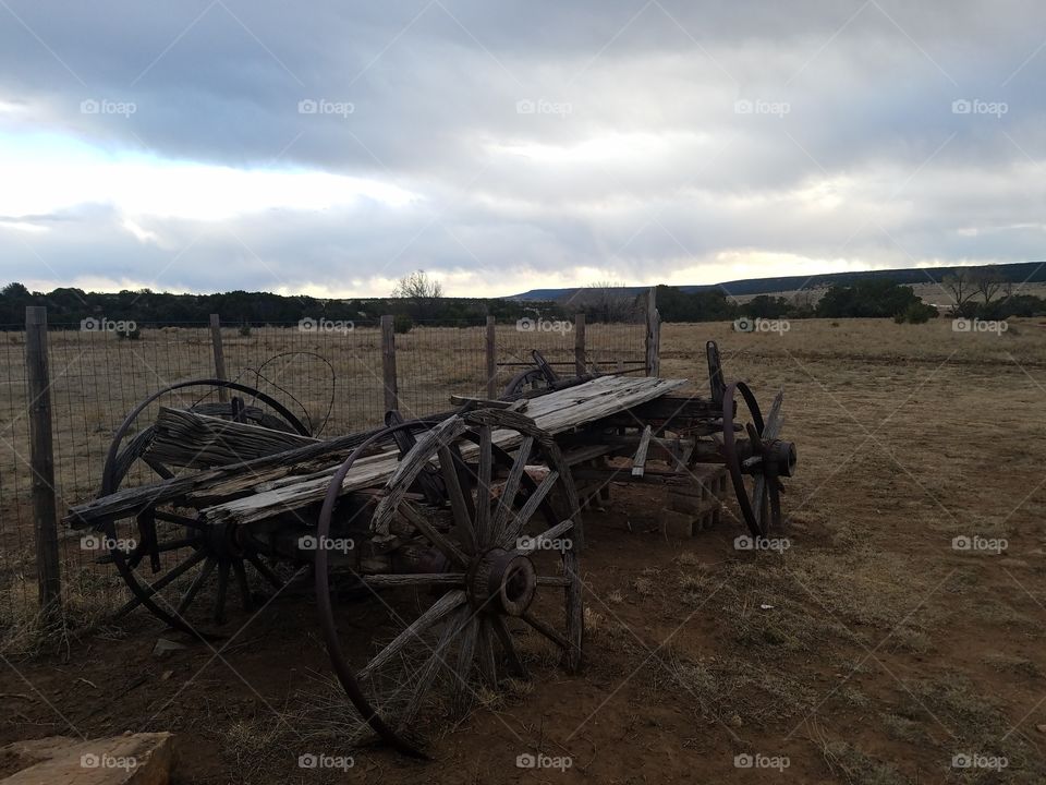 Old wagon and dark clouds