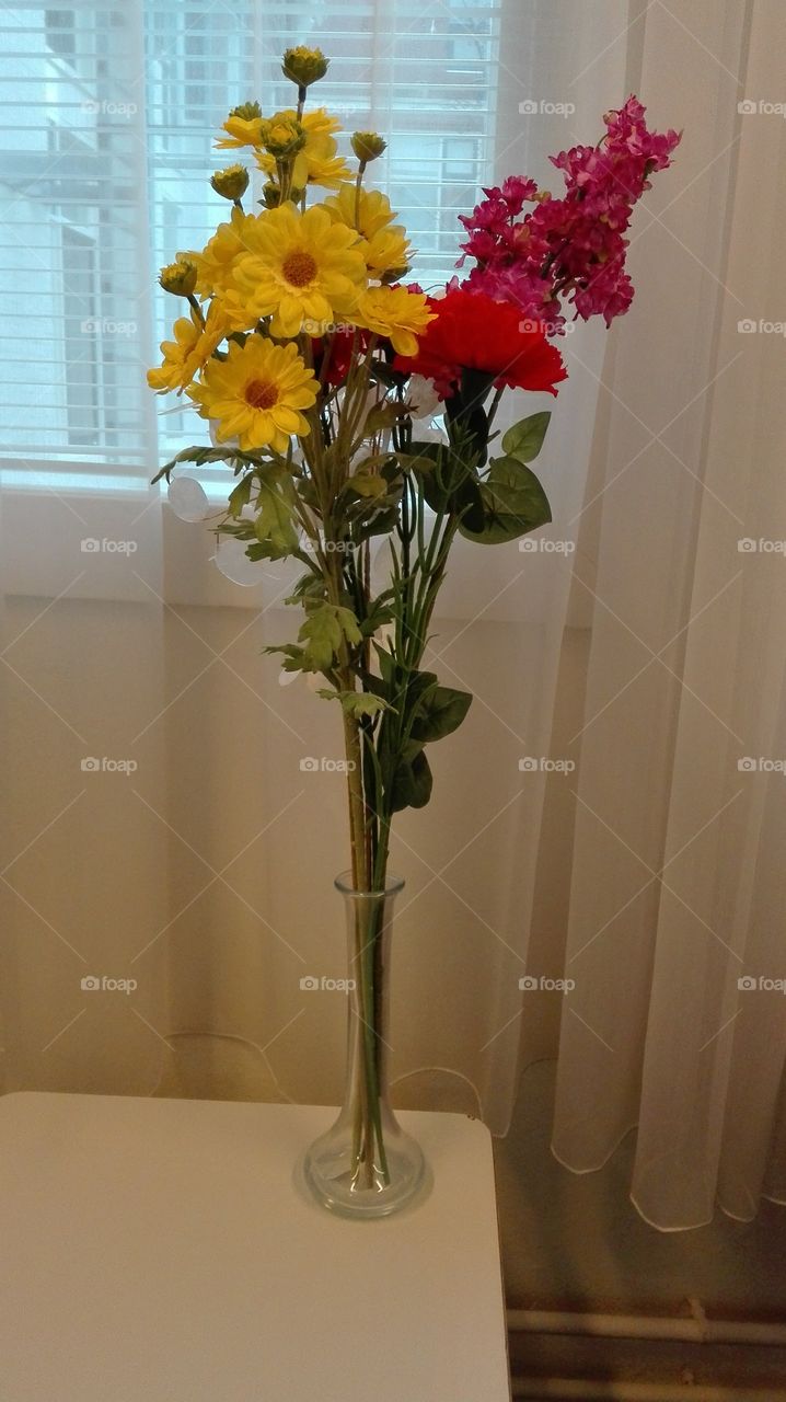 Tall vase of flowers.