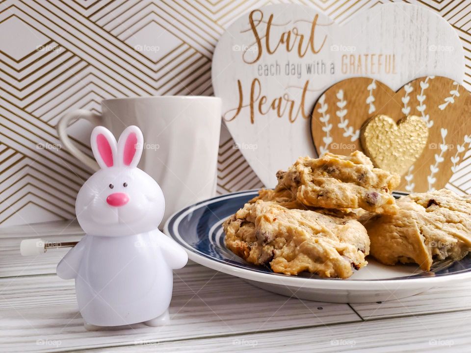 The Year of the Rabbit. A symbolic representation with a wind up Rabbit. We often wind up and run non stop, but in the year of the Rabbit it is time to slow down, reflect, have hope and peace. Maybe enjoy some cookies and tea.