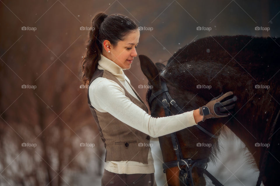 Young beautiful woman with horse outdoor portrait at spring day