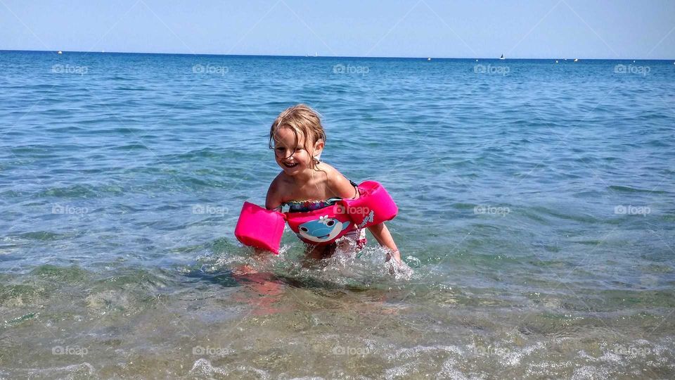 Little girl in ocean shore