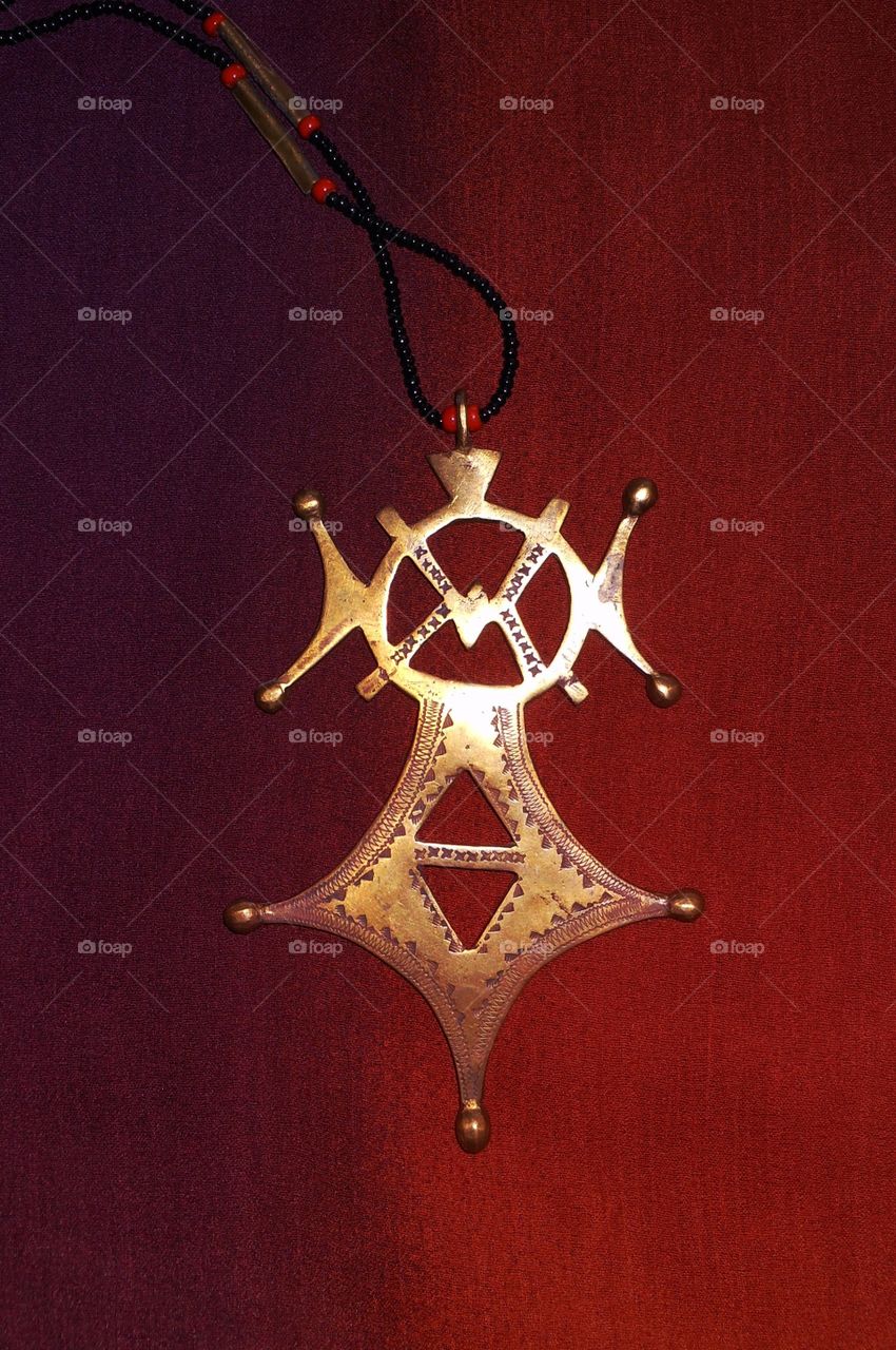 Tuareg pendant on red background 