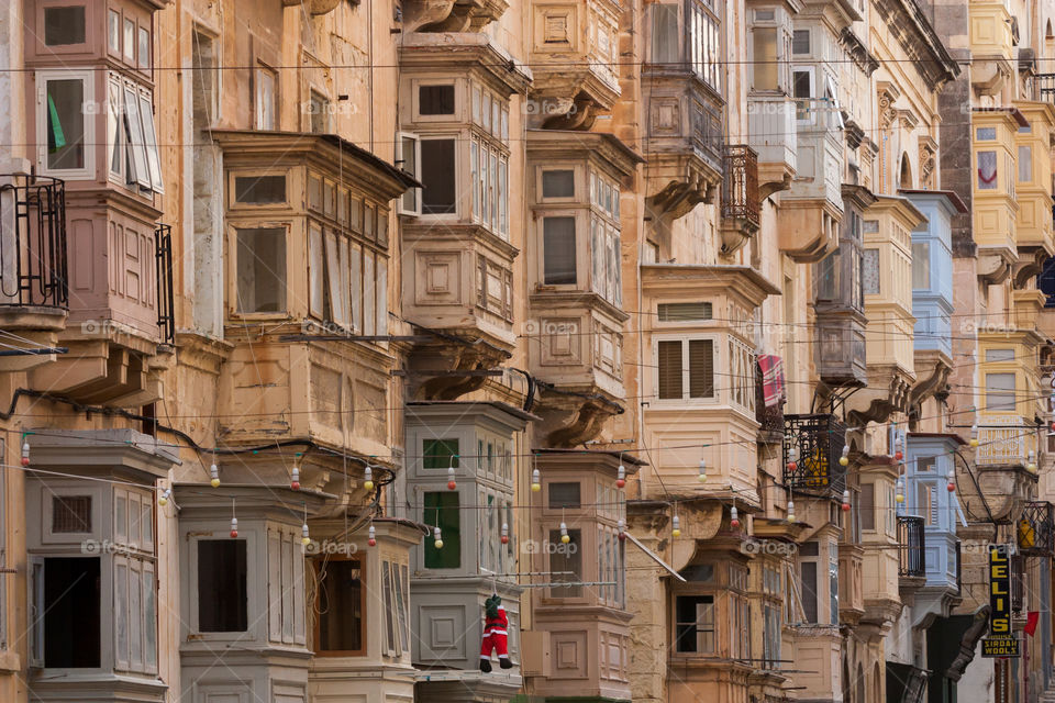 Side of a house is full of closed balconies. Location Malta. 