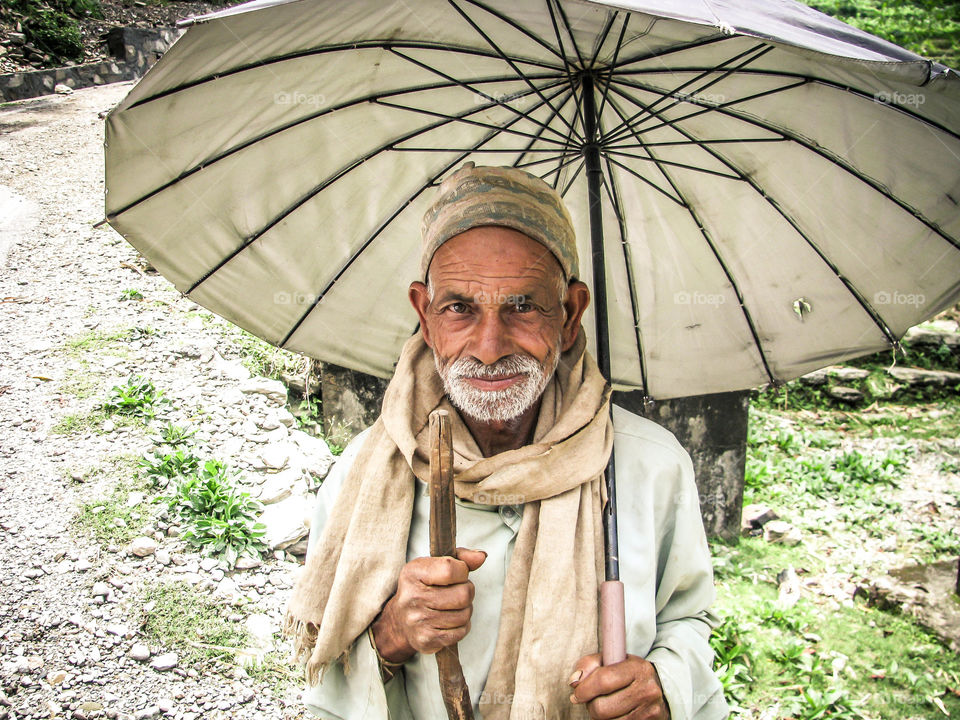 Portrait old man holding umbrella