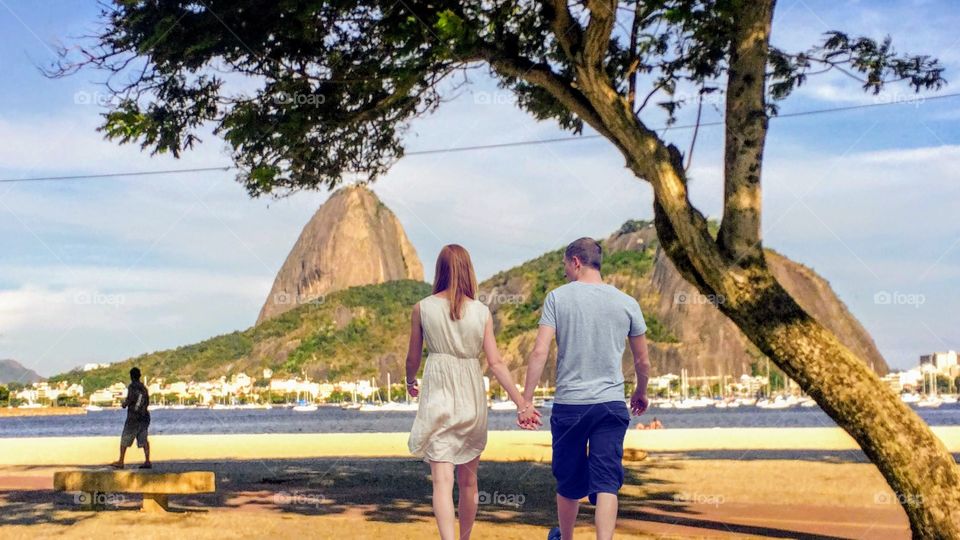 Couple walking on the edge of Rio De Janeiro, Brazil