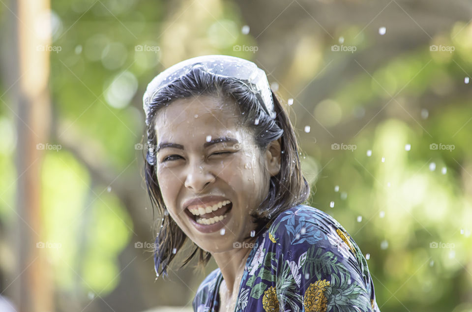 Asian woman play water in Songkran festival or Thai new year in Thailand.