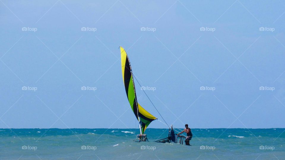 Fisherman with his raft on the high seas