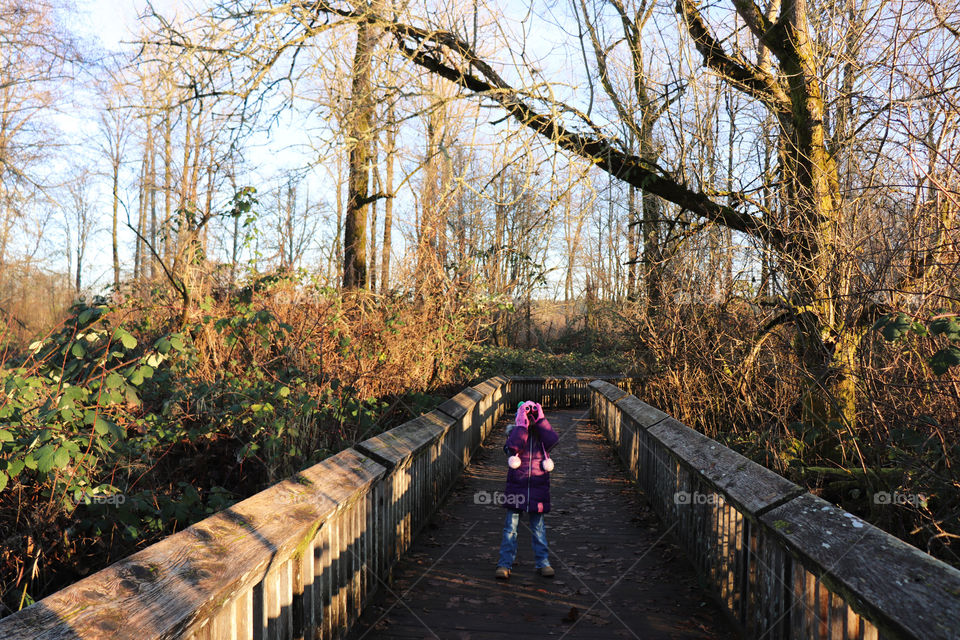 Girl looking for birds up in a tree