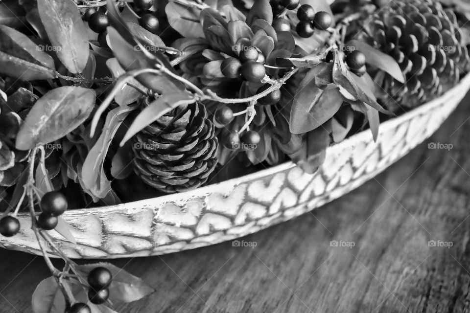 Bowl with pine cones and flowers