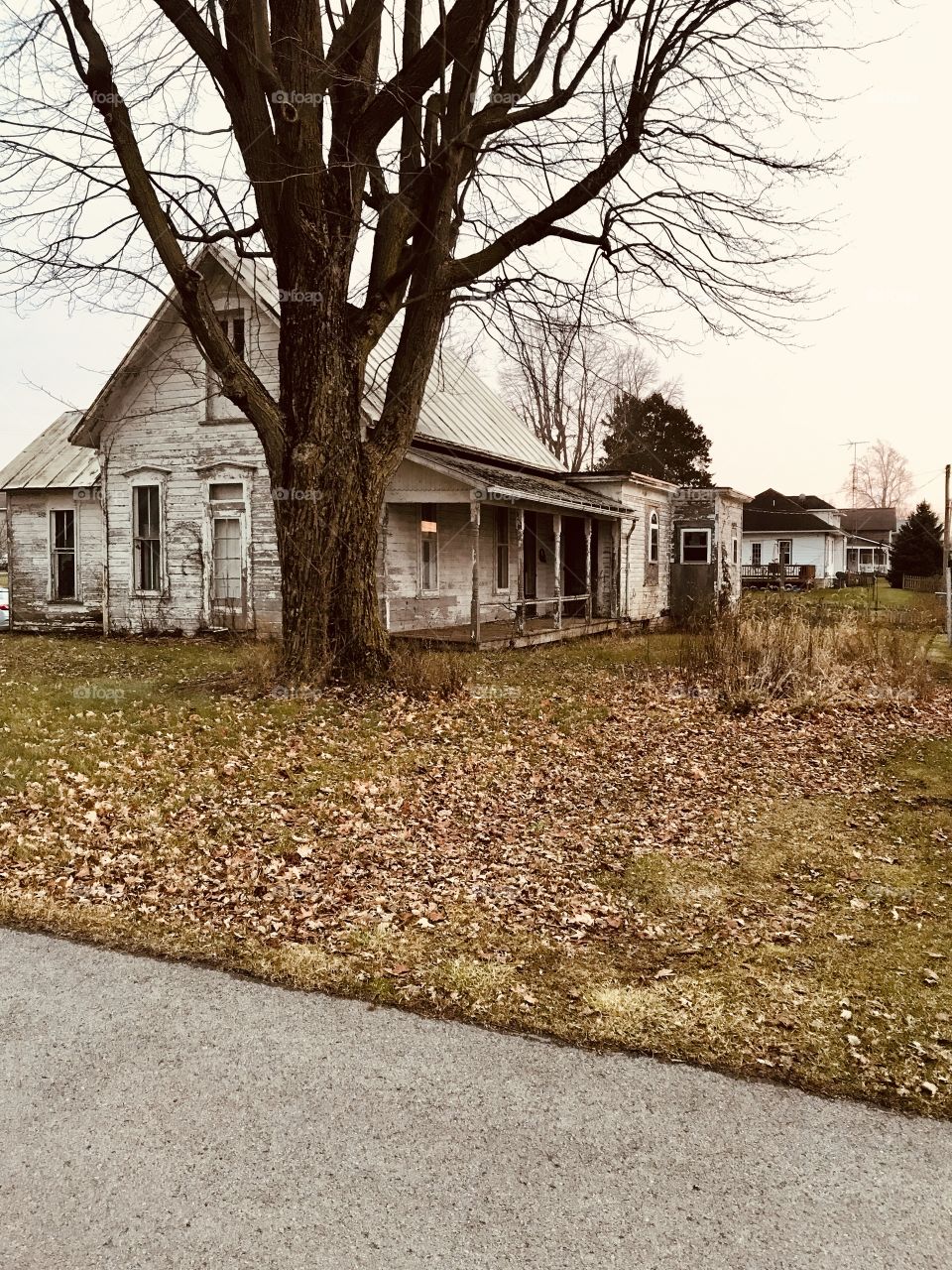 Old abandoned white farmhouse in Jenera Ohio in winter 