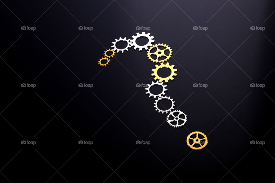 question mark with cogwheels / gears on black background