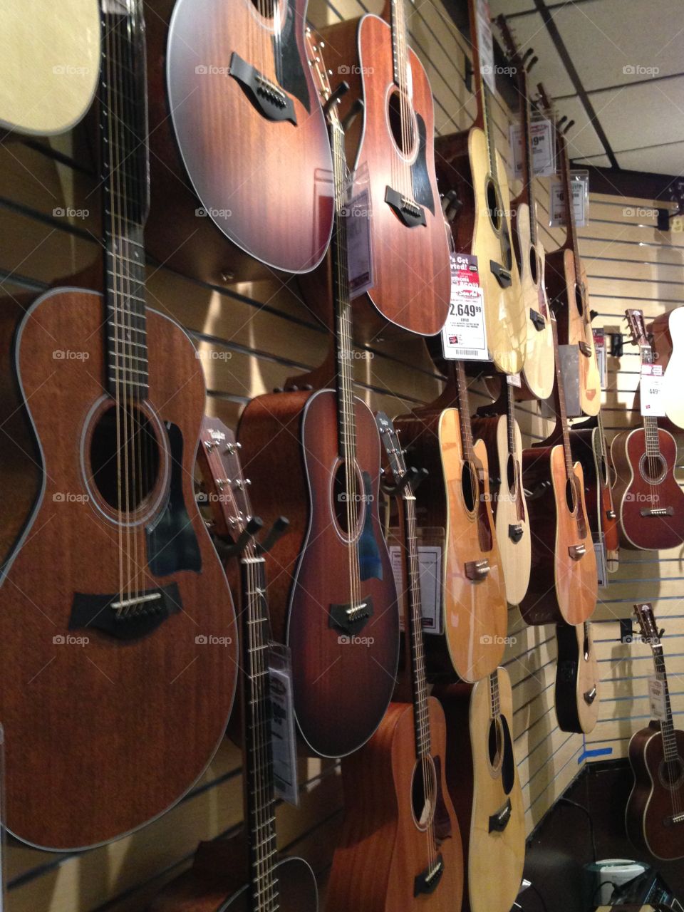 Display wall of guitars