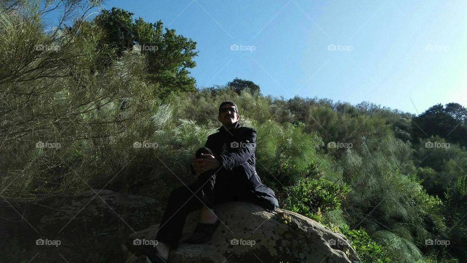 Im sitting on a bic rock. in nature.