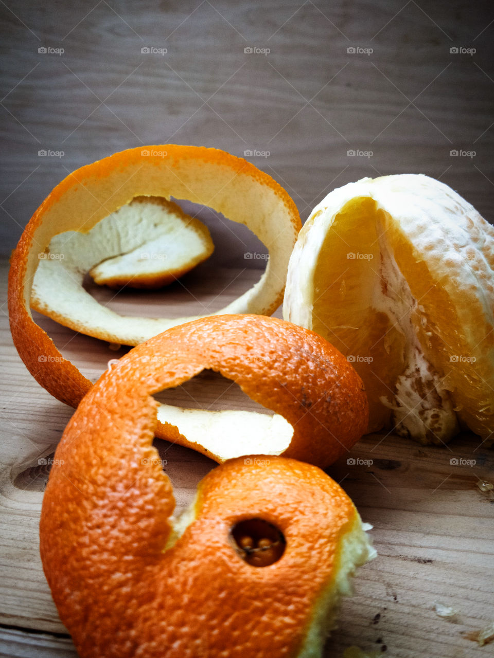 Peeled orange and orange zest in the form of a spiral