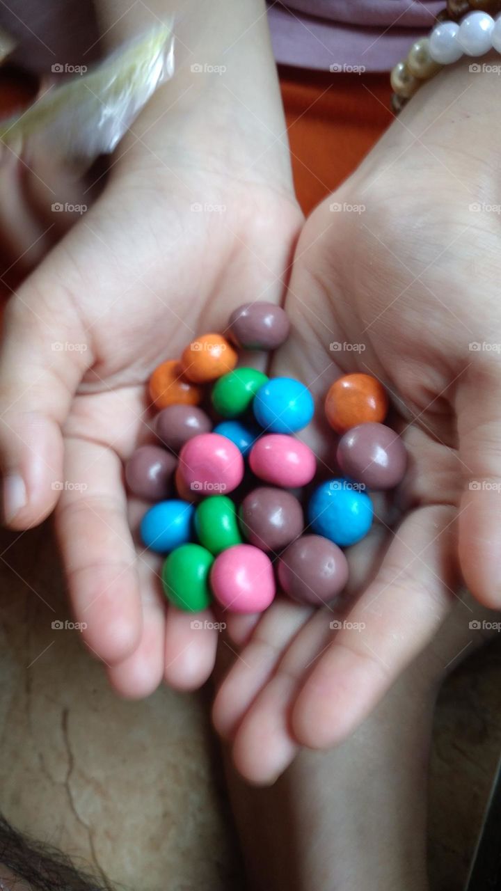 Colorful candy in the palm of the hand