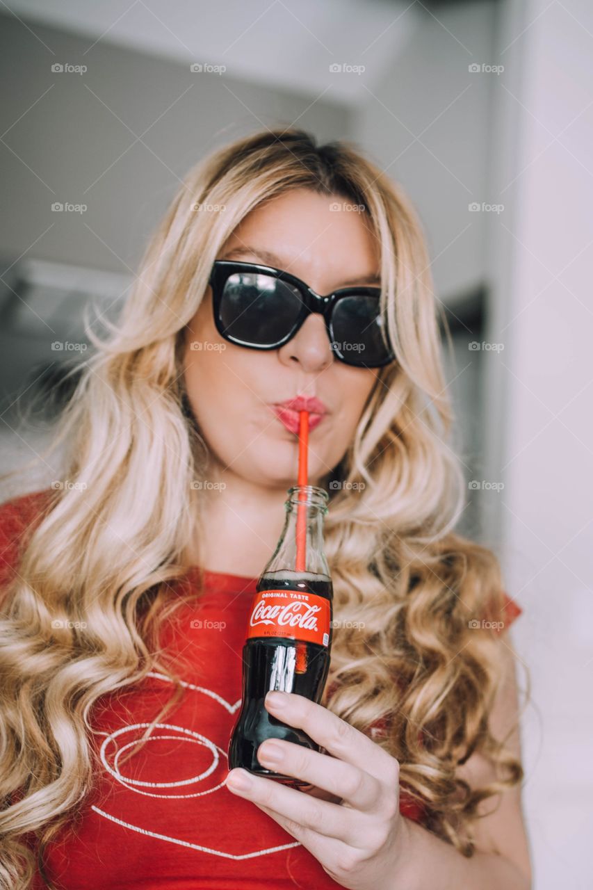 Girl drinking Coca Cola 