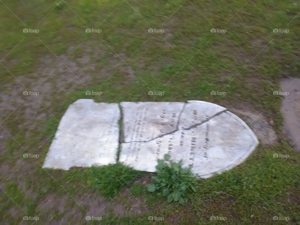 tombstone laying on ground