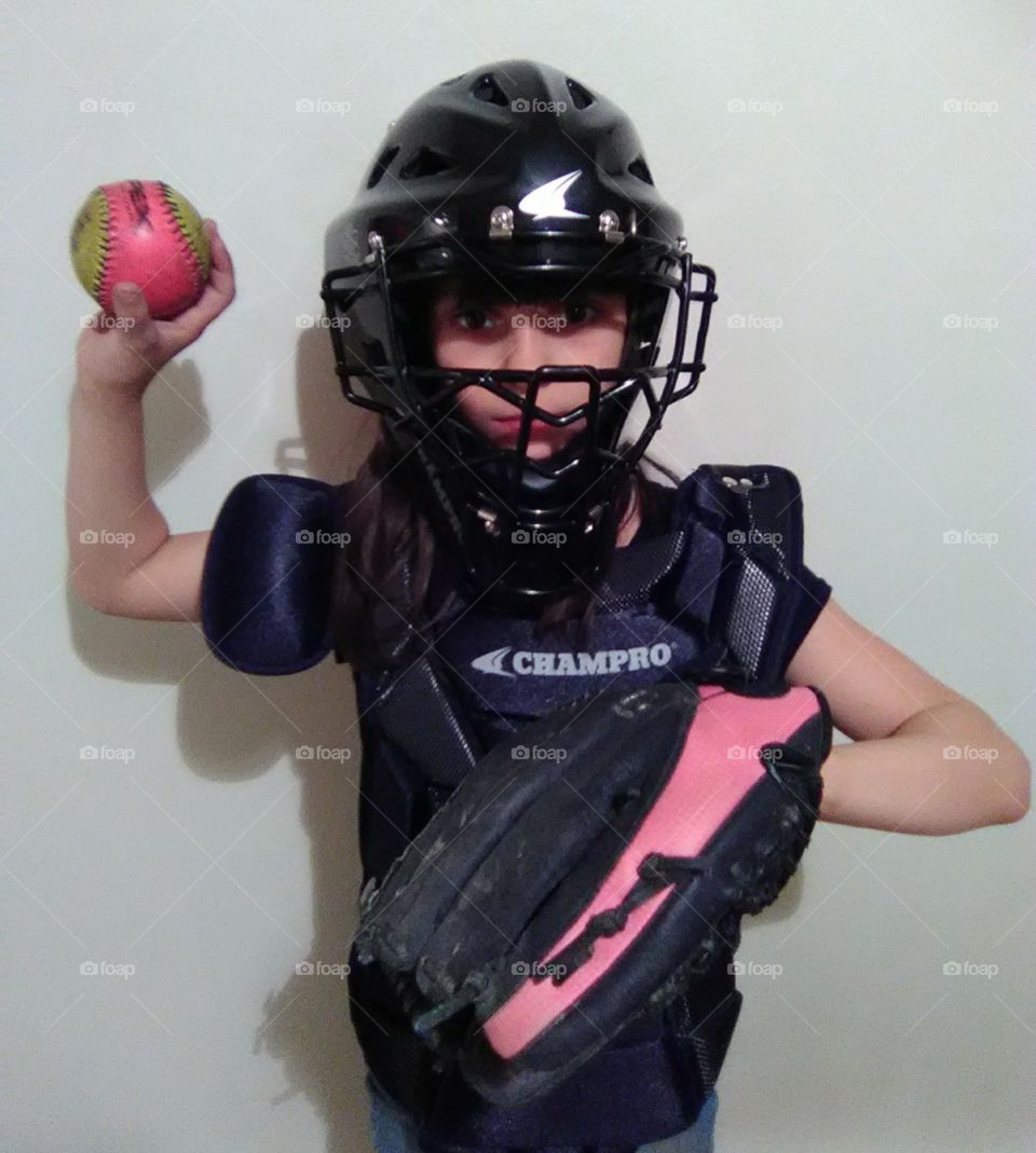 ready for the game this new little catcher is exited to join her team in helping win the game safety first
