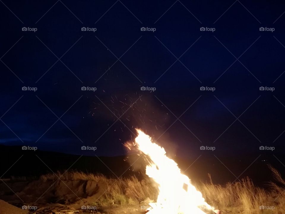 a beautiful picture of a bonfire at in the early morning as you can see the fire is burning