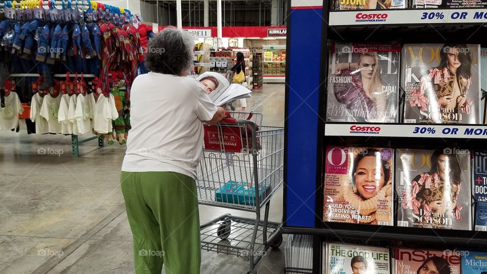 This woman was shopping and took the time to see if the magazine was interesting enough.