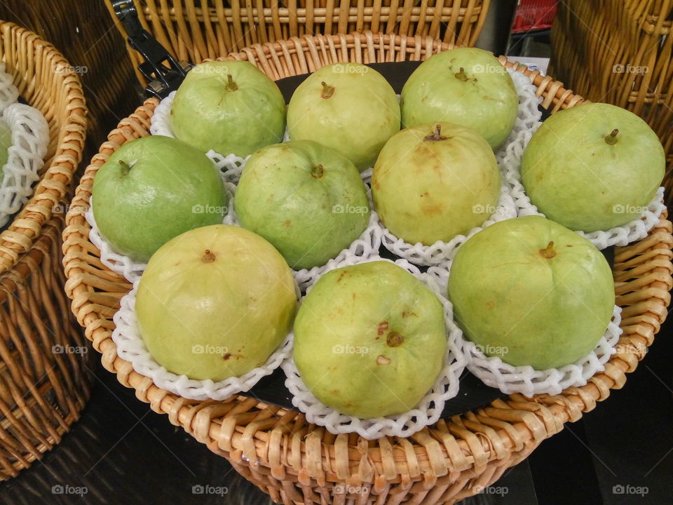 close up to guava in a basket
