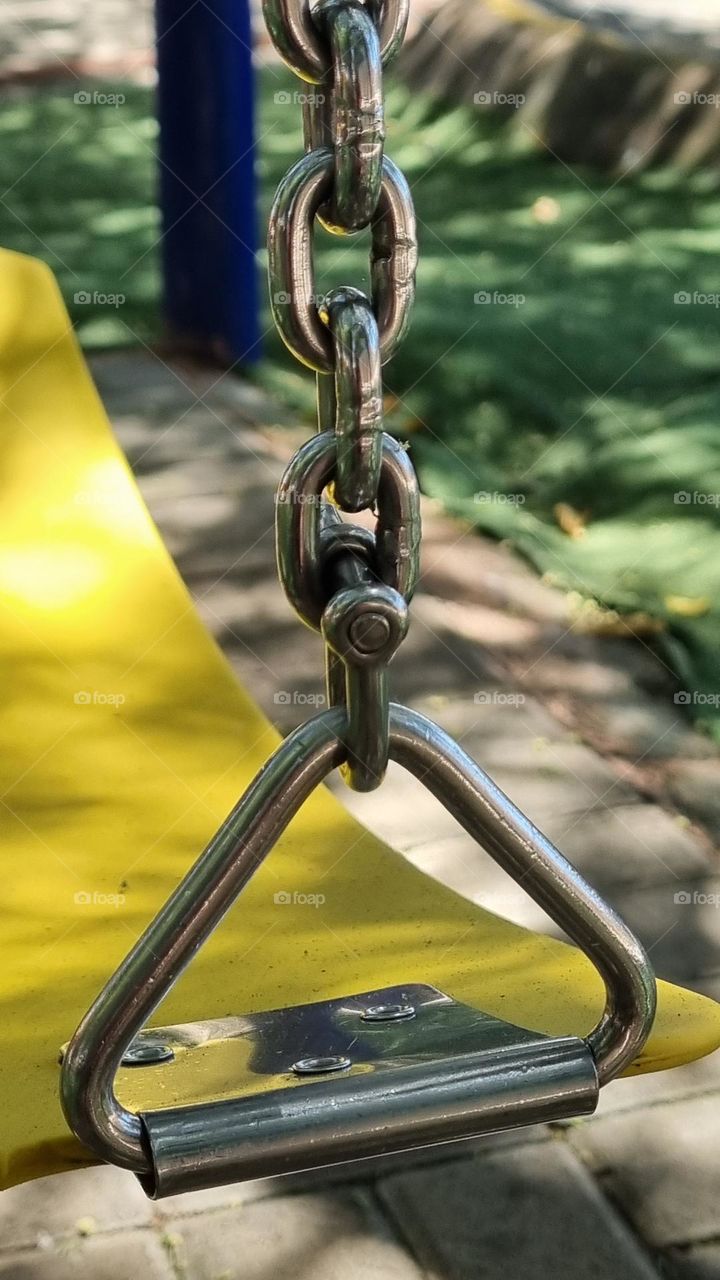 metal triangle connecting the seat and the chain of a swing