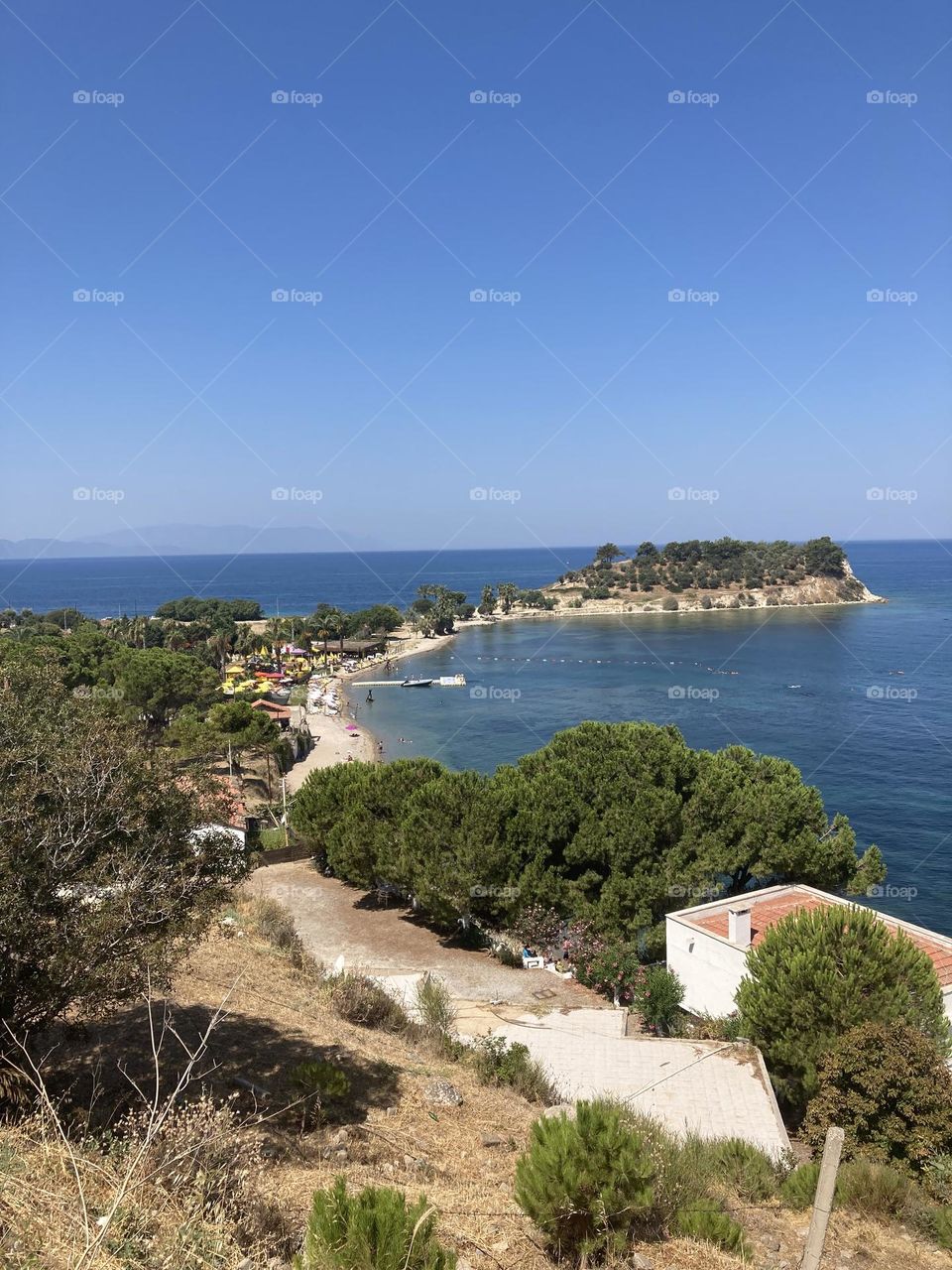 Beach time on holidays. Blue sky and tall palm trees. Sunsets and sunny days. Summertime in Kusadasi. Vacation travel in Turkey . Summer view. Sunny day during vacation 