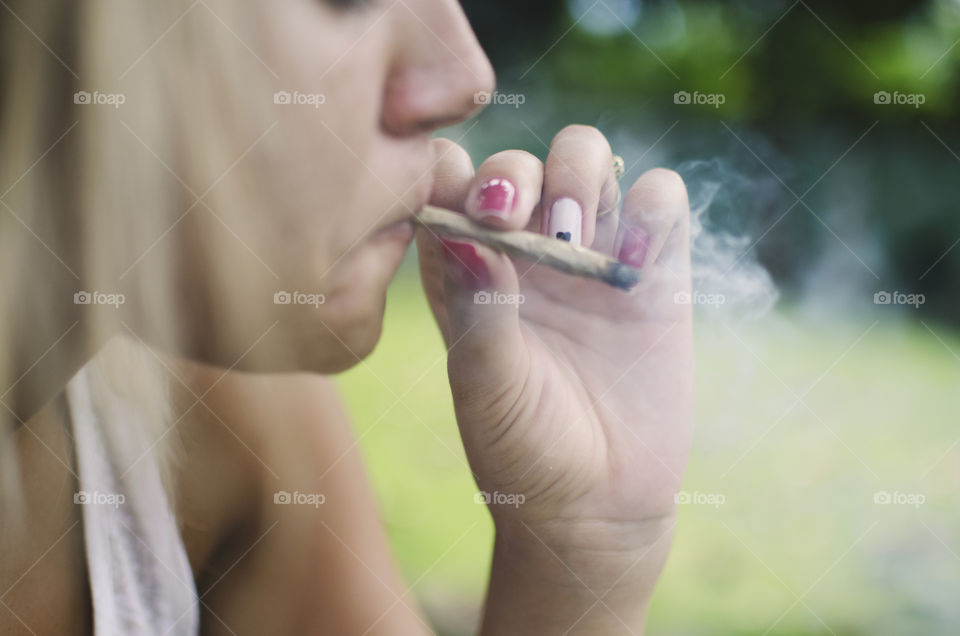 Woman smoking a cannabis joint