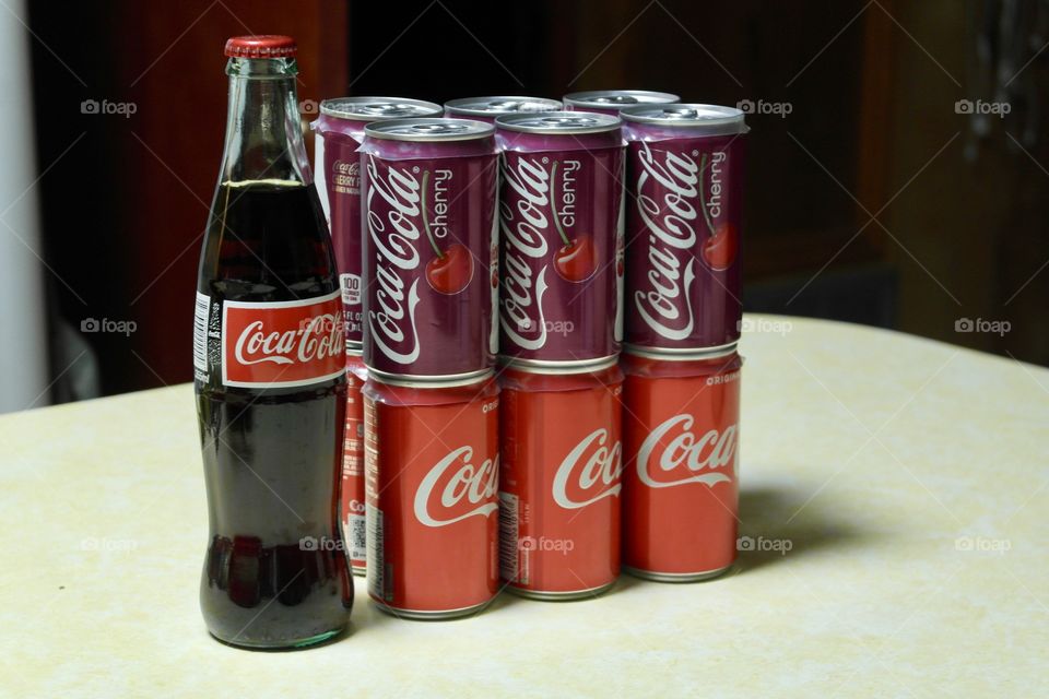 Coca Cola and cherry coke cans and glass bottle 