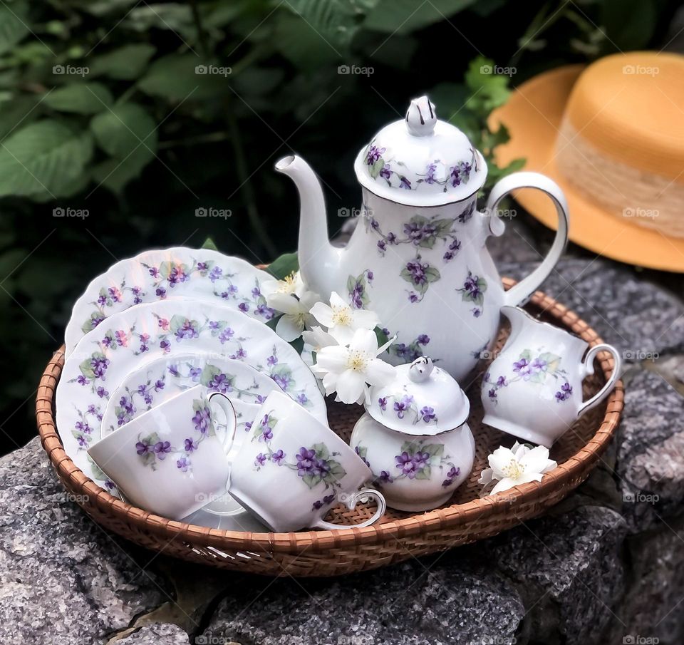 Old porcelain crockery with violets pattern and apple blossoms 