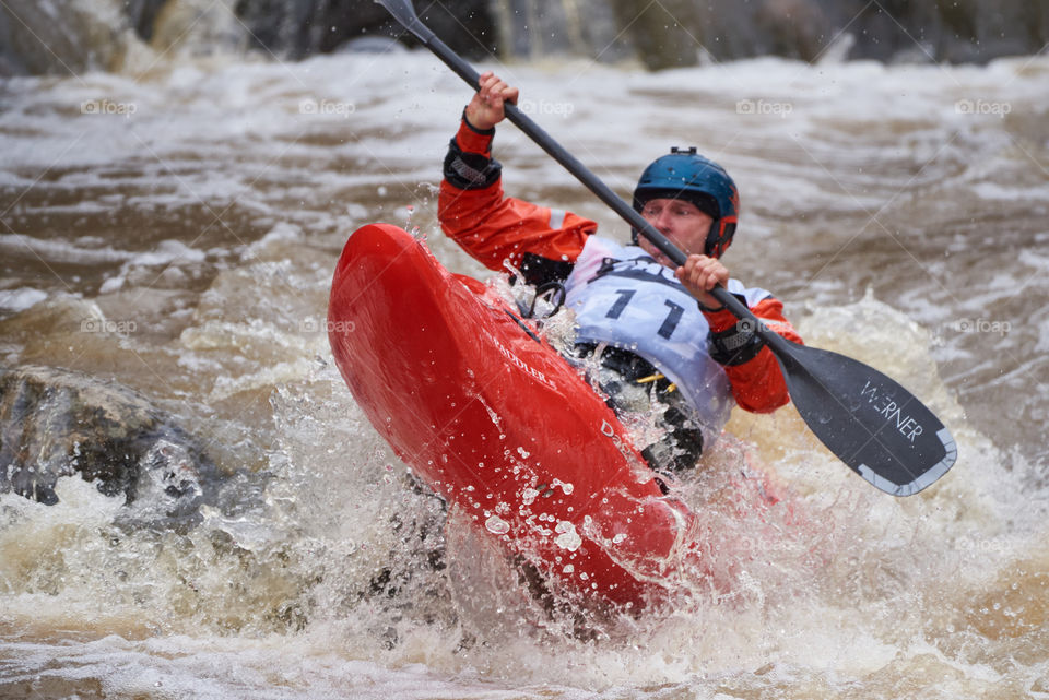 Helsinki, Finland -  April 15, 2018: Unidentified racer at the annual Icebreak 2018 whitewater kayaking competition at the Vanhankaupunginkoski rapids in Helsinki, Finland.