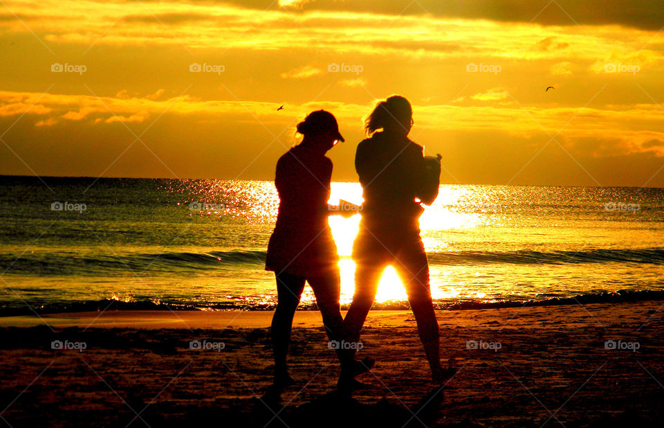 An amazing silhouette of a family at the beach