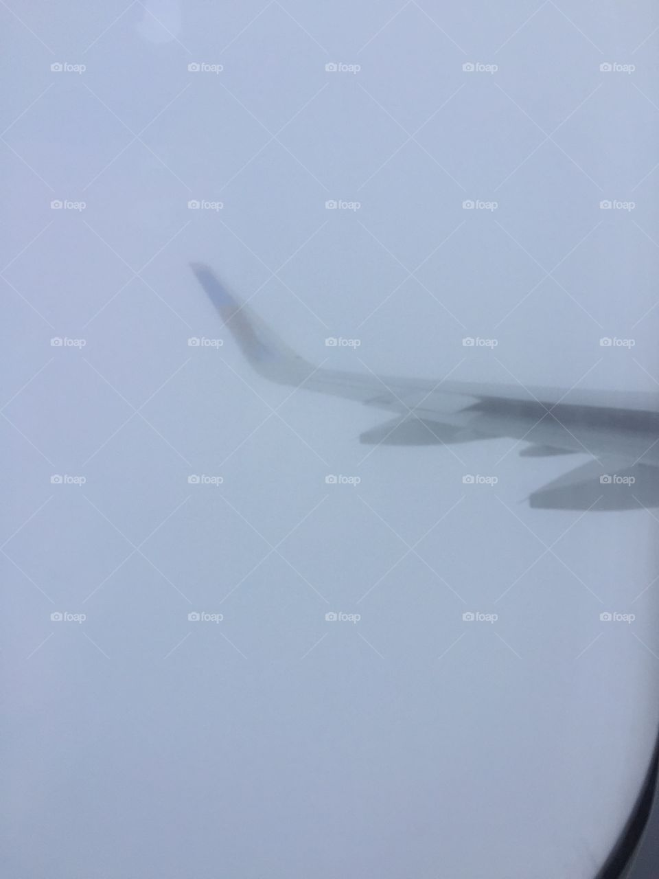 View of aircraft wing in cloud