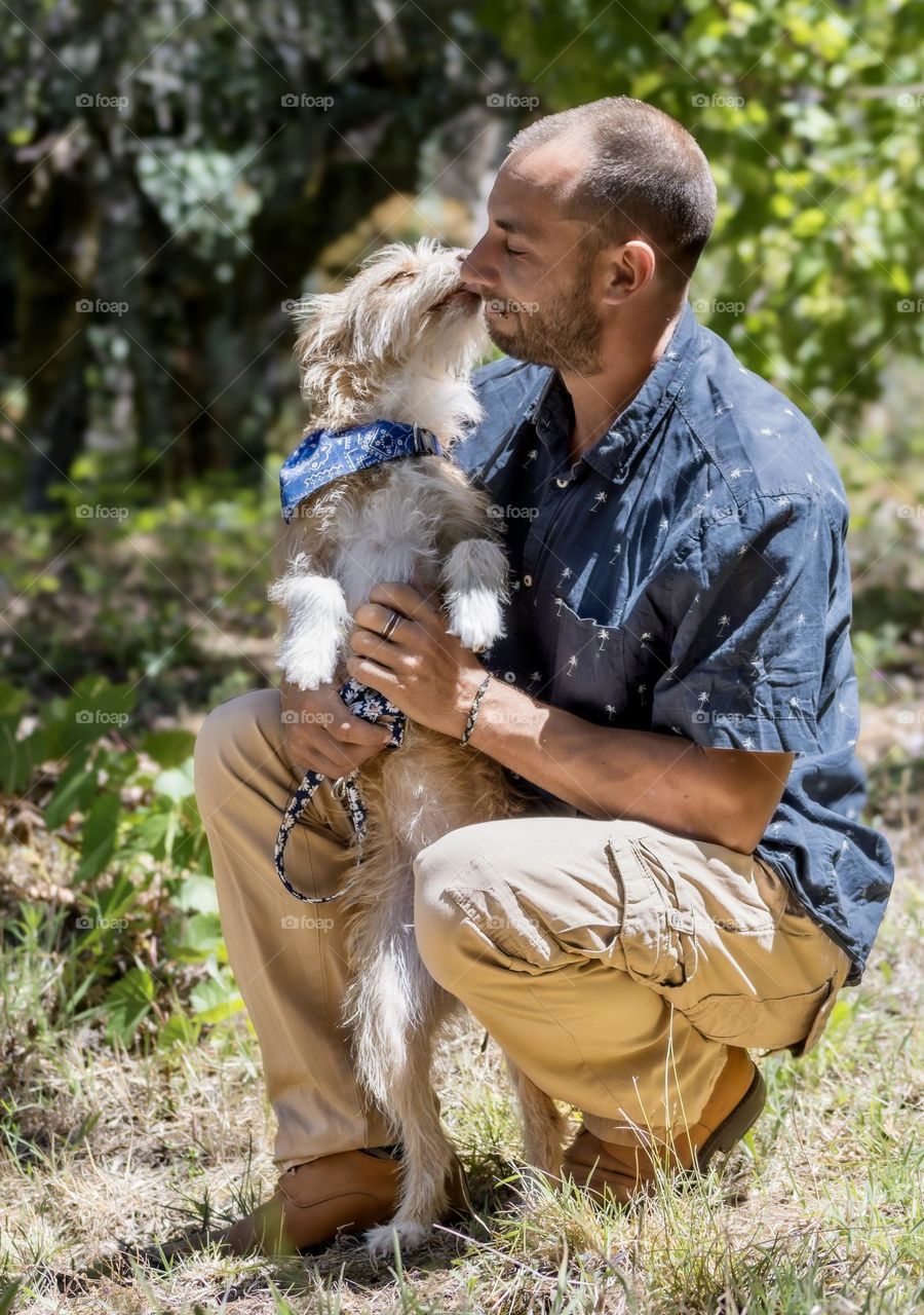 Terrier dog licks her person’s nose