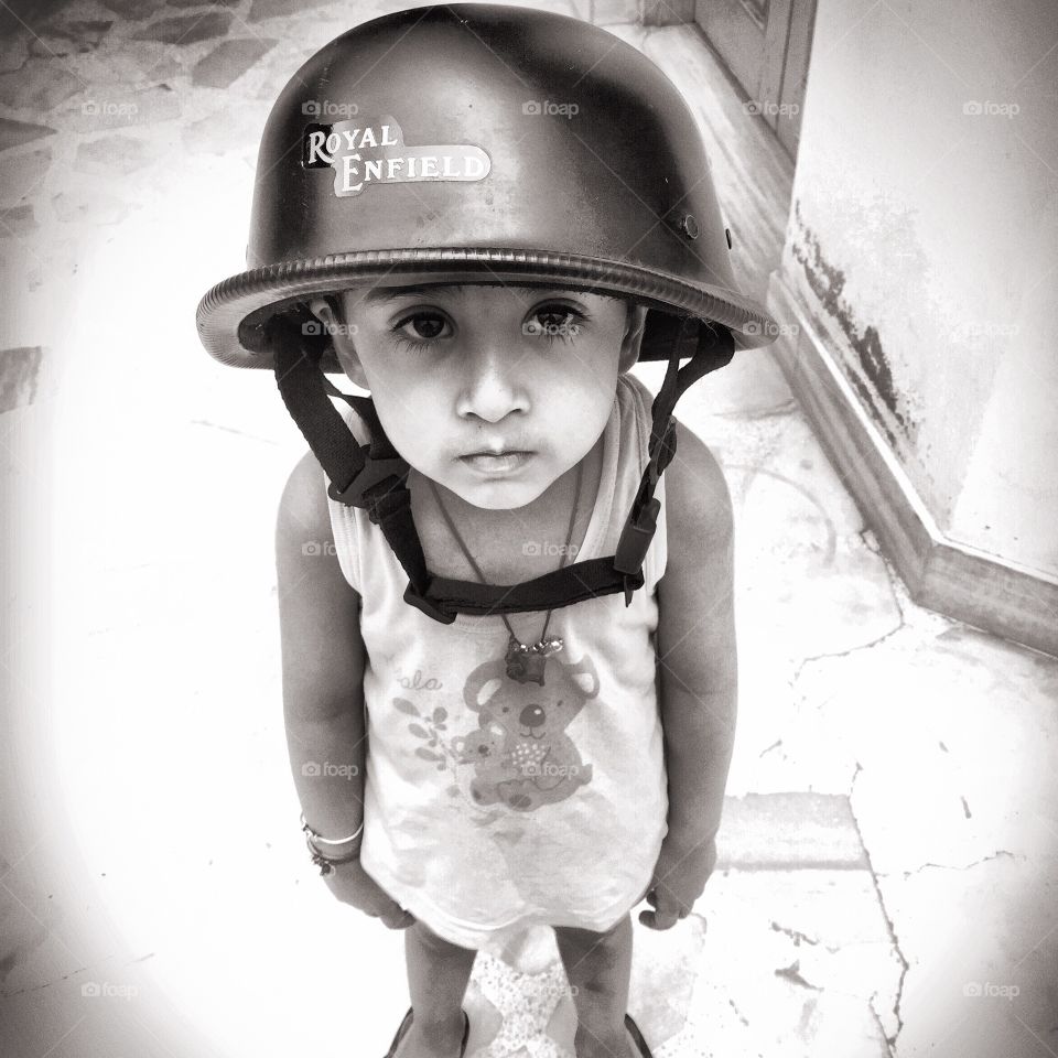 Close-up of a little boy wearing helmet